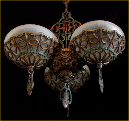 Title: Gill Glass Company Light Fixture - Description: 1930s Art Deco three light ceiling fixture by the Gill Glass Co.
Original polychrome finish in antique gold, red and green on elaborate cast frame plus three bowl style glass shades with finials.