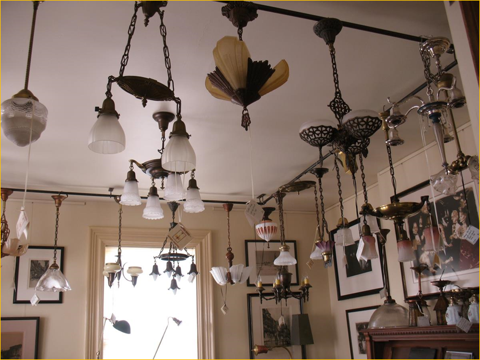 Title: Antique Lighting - Description: Interior photo of Harris House Antique Lighting near Halifax, Nova Scotia showing a selection of restored and rewired vintage ceiling fixtures.